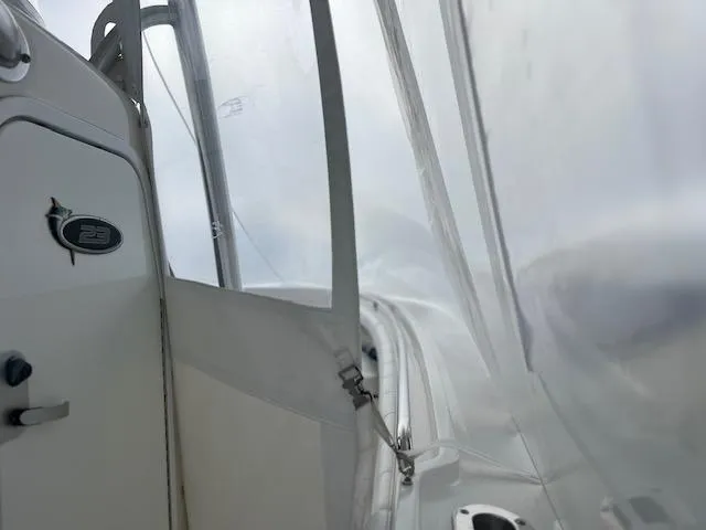 Slide: The Image of 2015 Regulator 23 Forward Seating boat interior with clear enclosure and visible controls. - 10