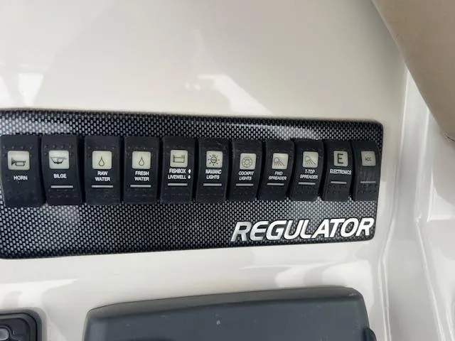 Slide: The Image of Control panel of 2015 Regulator 23 Forward Seating boat with labeled switches. - 20