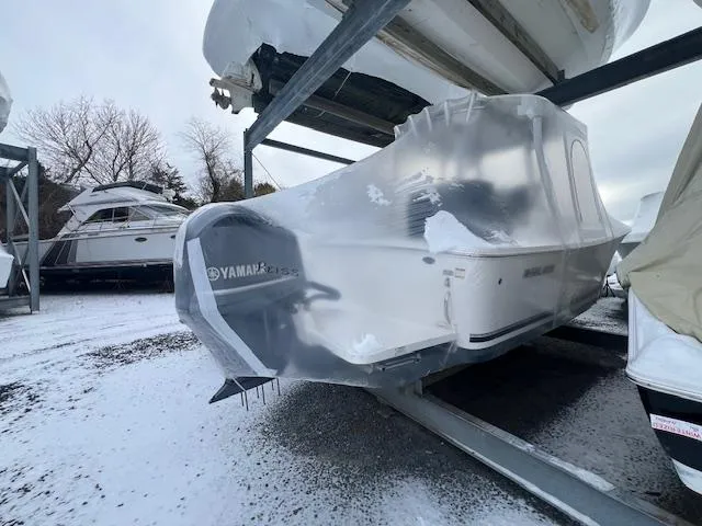 Slide: The Image of 2015 Regulator 23 Forward Seating boat, shrink-wrapped, stored outdoors in snowy conditions. - 7