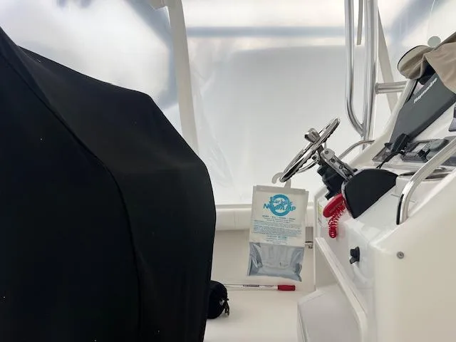 Slide: The Image of 2015 Regulator 23 Forward Seating boat interior with steering wheel and controls. - 9