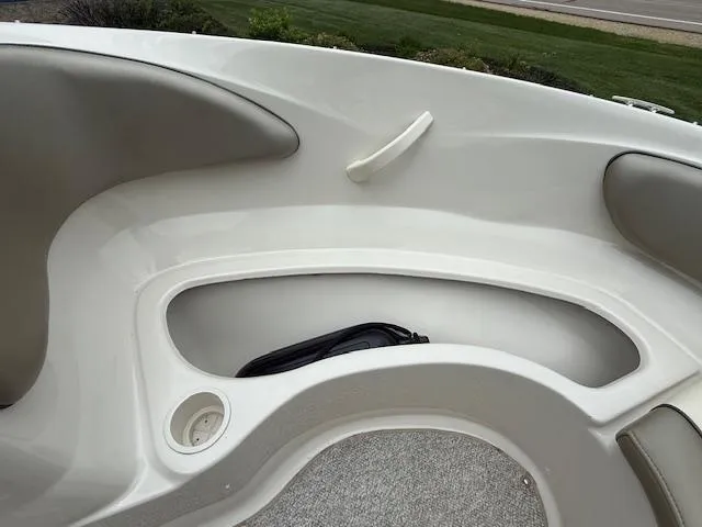 Slide: The Image of 2005 Sea Ray 200 Sport boat interior with seating and storage compartment. - 13