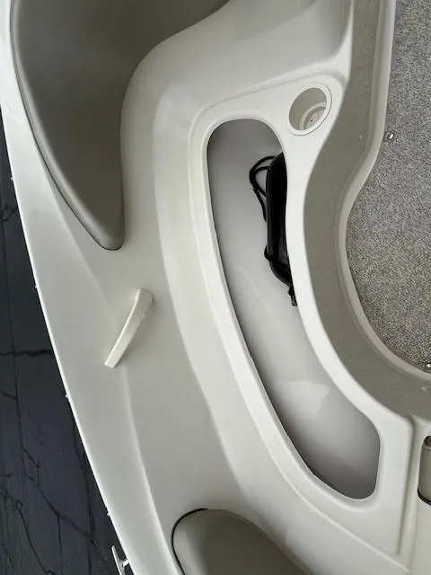 Slide: The Image of Interior view of a 2005 Sea Ray 200 Sport boat, featuring seating and storage areas. - 14