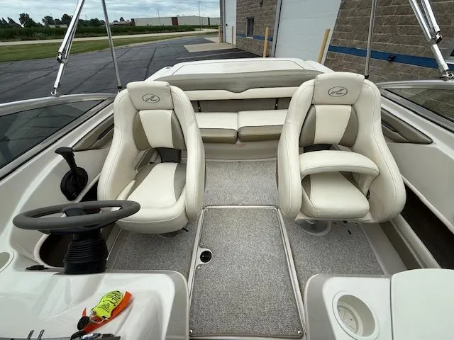Slide: The Image of 2005 Sea Ray 200 Sport boat interior with white seating and steering wheel. - 15