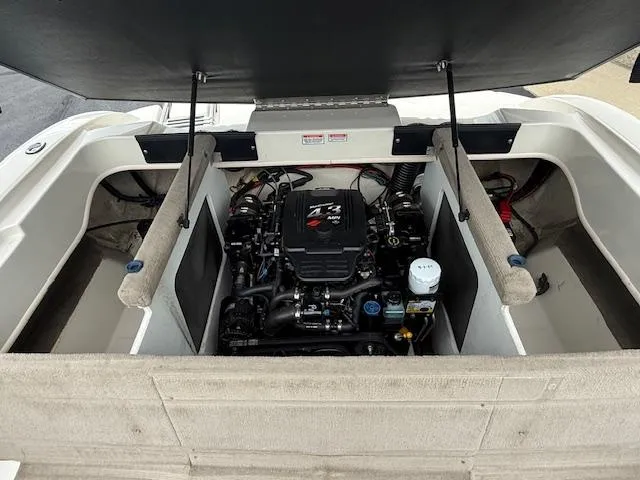 Slide: The Image of 2005 Sea Ray 200 Sport boat engine compartment with open hatch, showcasing engine details. - 17