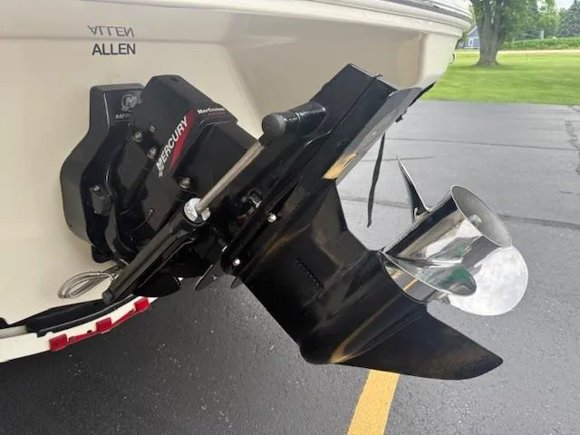 Slide: The Image of 2005 Sea Ray 200 Sport boat with Mercury outboard motor, parked on asphalt. - 20