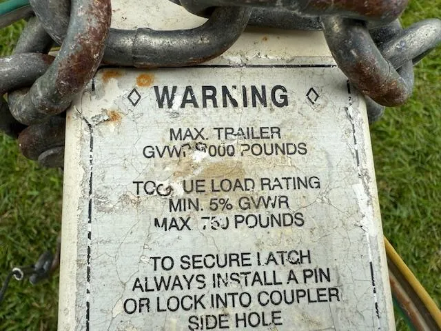 Slide: The Image of Warning label on trailer hitch with load specifications and safety instructions. - 24