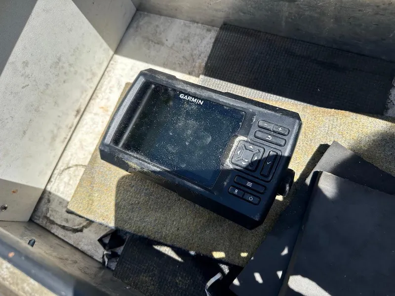 Slide: The Image of Garmin device on 1998 Klamath 14 DLX boat floor, sunlight casting shadows. - 14