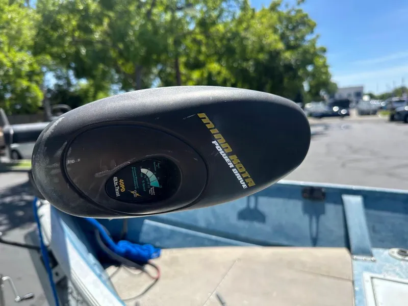 Slide: The Image of Minn Kota PowerDrive motor on 1998 Klamath 14 DLX boat, sunny day background. - 17