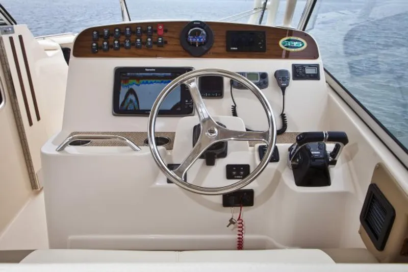 Slide: The Image of Manufacturer Provided Image: 2014 Grady-White Freedom 335 boat helm with steering wheel, controls, and navigation equipment. - 5