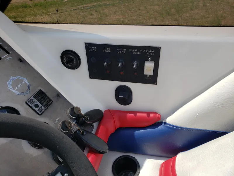 Slide: The Image of 1990 Fountain 27 Fever boat dashboard with control panel and steering wheel. - 3