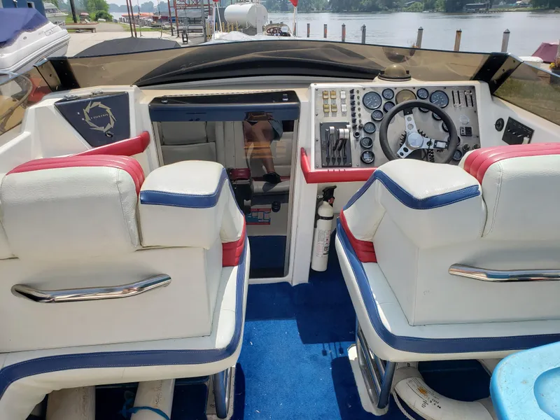 Slide: The Image of Interior of a 1990 Fountain 27 Fever boat with white and red seating. - 4