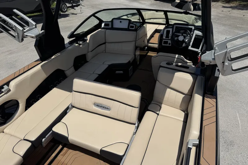Slide: The Image of 2020 Supra SE 450 boat interior with beige seating and modern dashboard. - 13