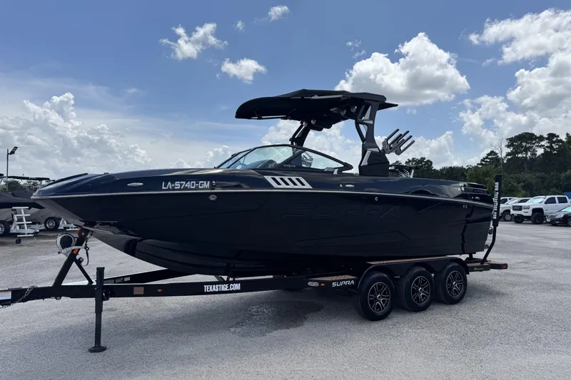 Slide: The Image of 2020 Supra SE 450 boat on trailer under blue sky with clouds. - 4