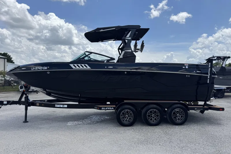 Slide: The Image of 2020 Supra SE 450 boat on trailer under cloudy sky. - 5