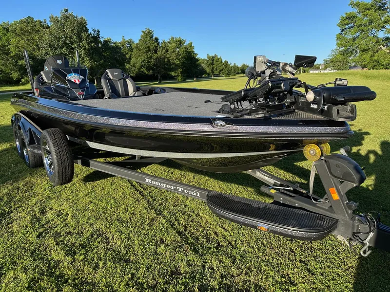 The Image of 2023 Ranger Z521R bass boat on trailer, parked on grass with trees in background. - 0