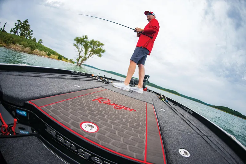 Slide: The Image of Man fishing on 2023 Ranger Z521R boat, scenic lake view. - 14