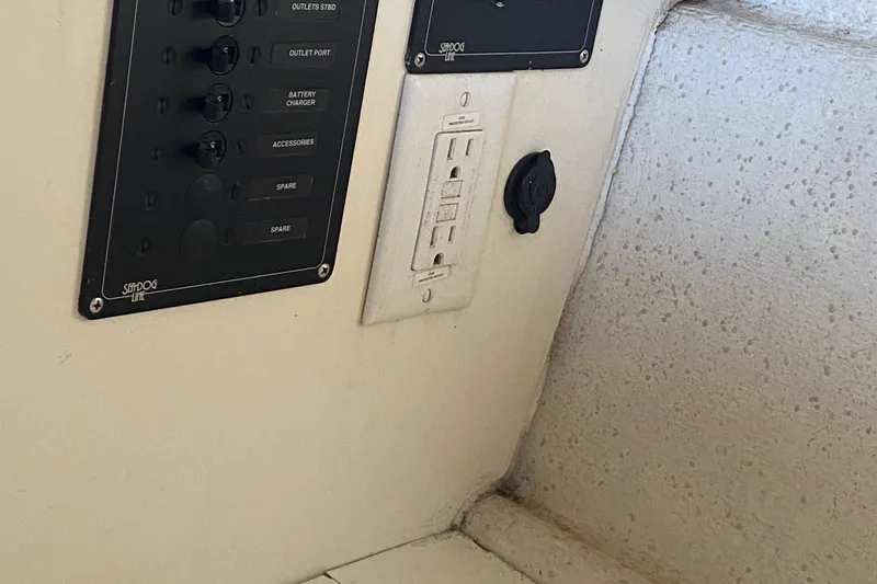 Slide: The Image of Electrical panel and outlet on a 2002 C-Dory 25' Cruiser boat interior. - 13