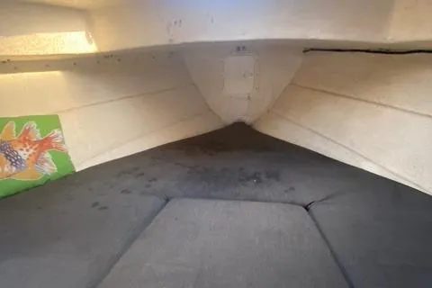 Slide: The Image of 2002 C-Dory 25' Cruiser interior cabin with cushioned seating and colorful wall art. - 14