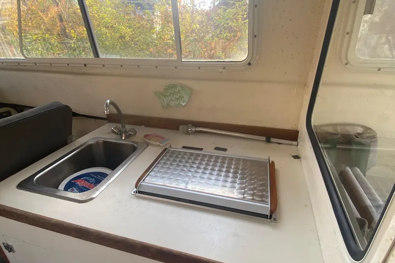 Slide: The Image of 2002 C-Dory 25' Cruiser interior with sink and countertop in cabin. - 17