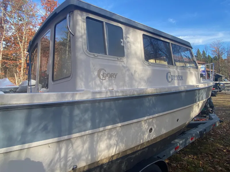 Slide: The Image of 2002 C-Dory 25' Cruiser boat on trailer, surrounded by autumn trees. - 3