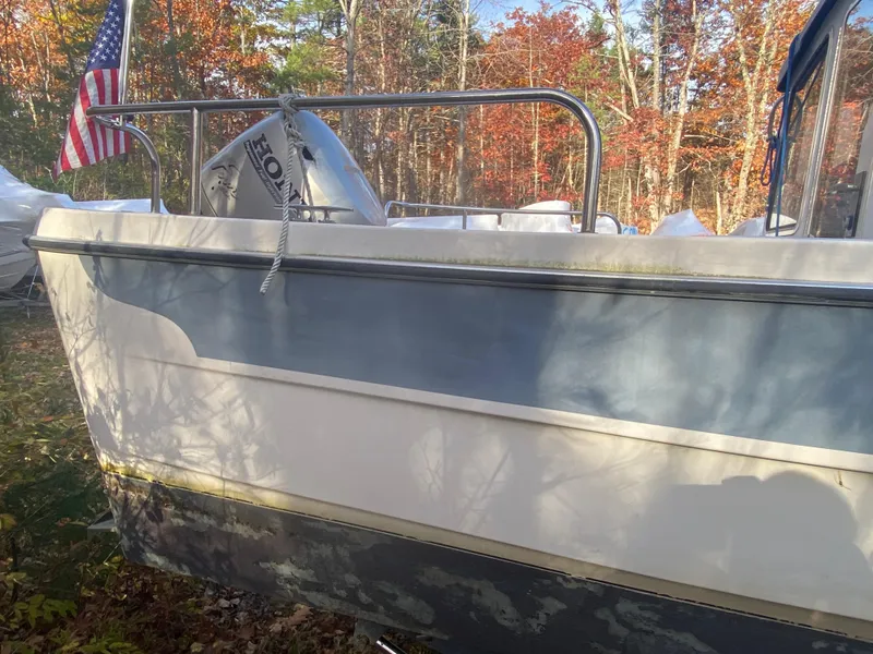 Slide: The Image of 2002 C-Dory 25' Cruiser boat with Honda motor, American flag, autumn forest background. - 7