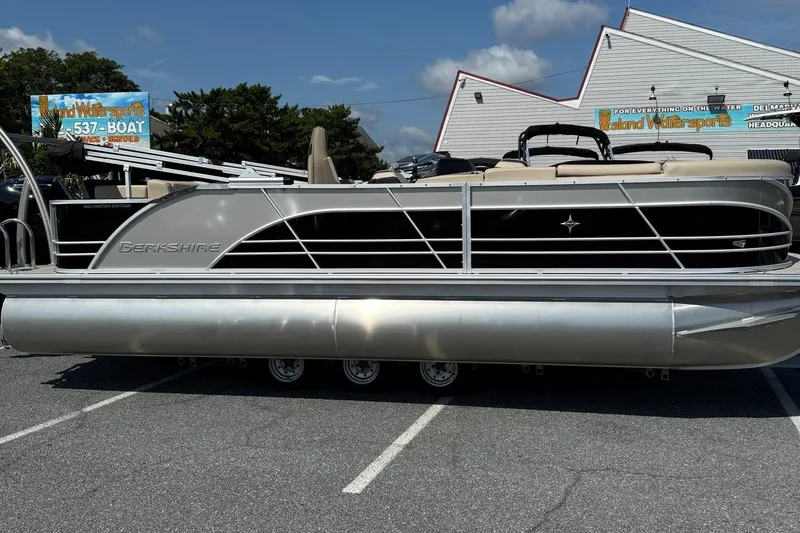 The Image of 2025 Berkshire 23CL STS 3.0 pontoon boat parked outdoors on a sunny day. - 1