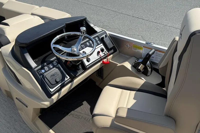 Slide: The Image of 2025 Berkshire 23CL STS 3.0 boat interior with steering wheel and control panel. - 11