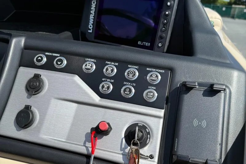 Slide: The Image of Control panel of 2025 Berkshire 23CL STS 3.0 boat with navigation and power switches. - 13