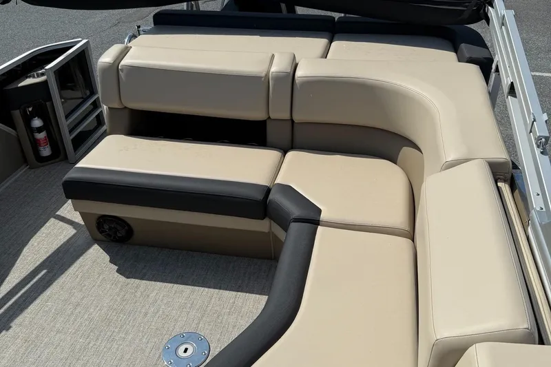 Slide: The Image of 2025 Berkshire 23CL STS 3.0 boat interior with beige and black seating. - 14