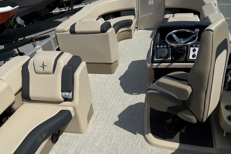 Slide: The Image of 2025 Berkshire 23CL STS 3.0 boat interior with beige seating and modern steering console. - 15