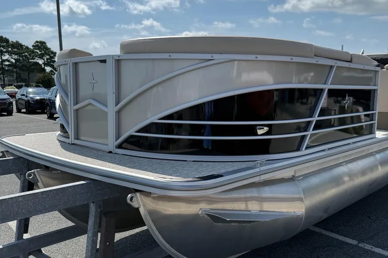 Slide: The Image of 2025 Berkshire 23CL STS 3.0 pontoon boat on trailer, parked outdoors. - 4