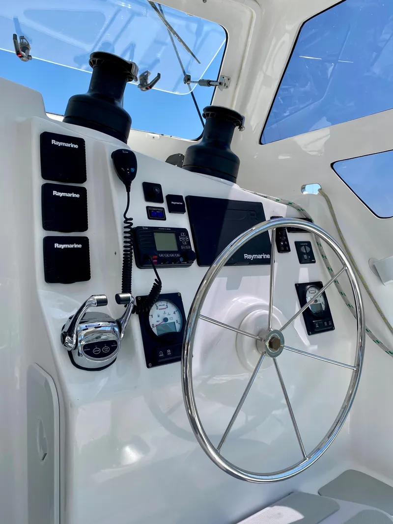 Slide: The Image of 2019 Royal Cape Catamarans 530 helm with navigation equipment and steering wheel. - 15