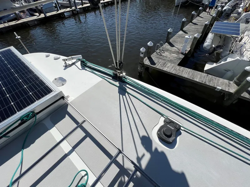 Slide: The Image of 2019 Royal Cape Catamarans Majestic 530 docked, featuring solar panels and deck details. - 17