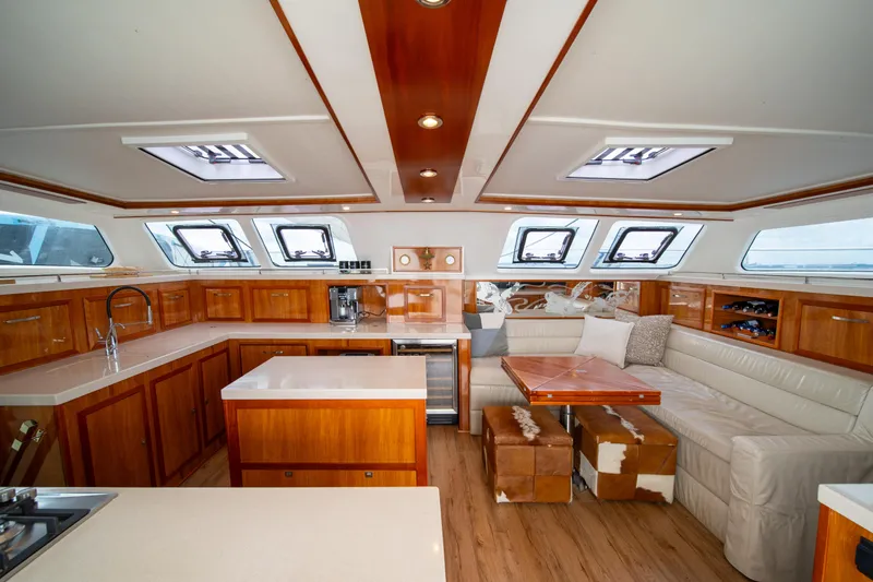Slide: The Image of Luxurious interior of 2019 Royal Cape Catamarans Majestic 530 with elegant wood finishes and seating. - 25