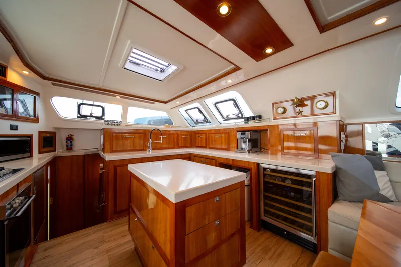 Slide: The Image of Luxurious interior of 2019 Royal Cape Catamarans Majestic 530, featuring modern kitchen and elegant wood finishes. - 27