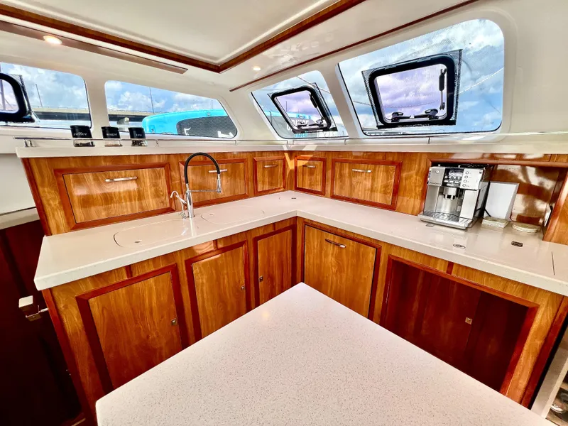 Slide: The Image of Luxurious 2019 Royal Cape Catamarans 530 kitchen with wood cabinetry and modern appliances. - 31