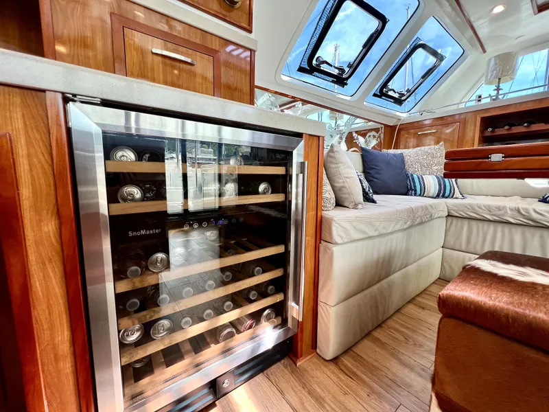 Slide: The Image of Luxurious 2019 Royal Cape Catamarans 530 interior with wine cooler and plush seating. - 33