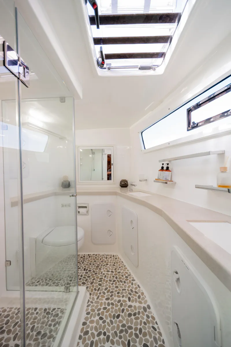 Slide: The Image of Luxurious bathroom in 2019 Royal Cape Catamarans Majestic 530 with modern fixtures and pebble flooring. - 39
