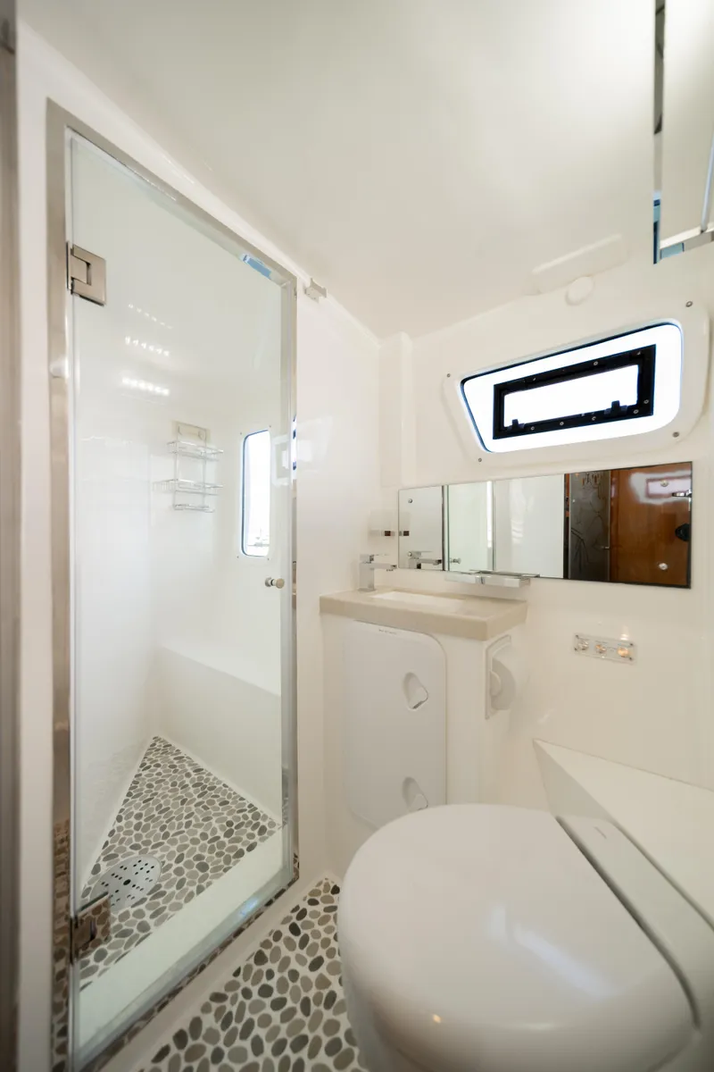 Slide: The Image of Luxurious bathroom in 2019 Royal Cape Catamarans Majestic 530 with modern fixtures and pebble flooring. - 41