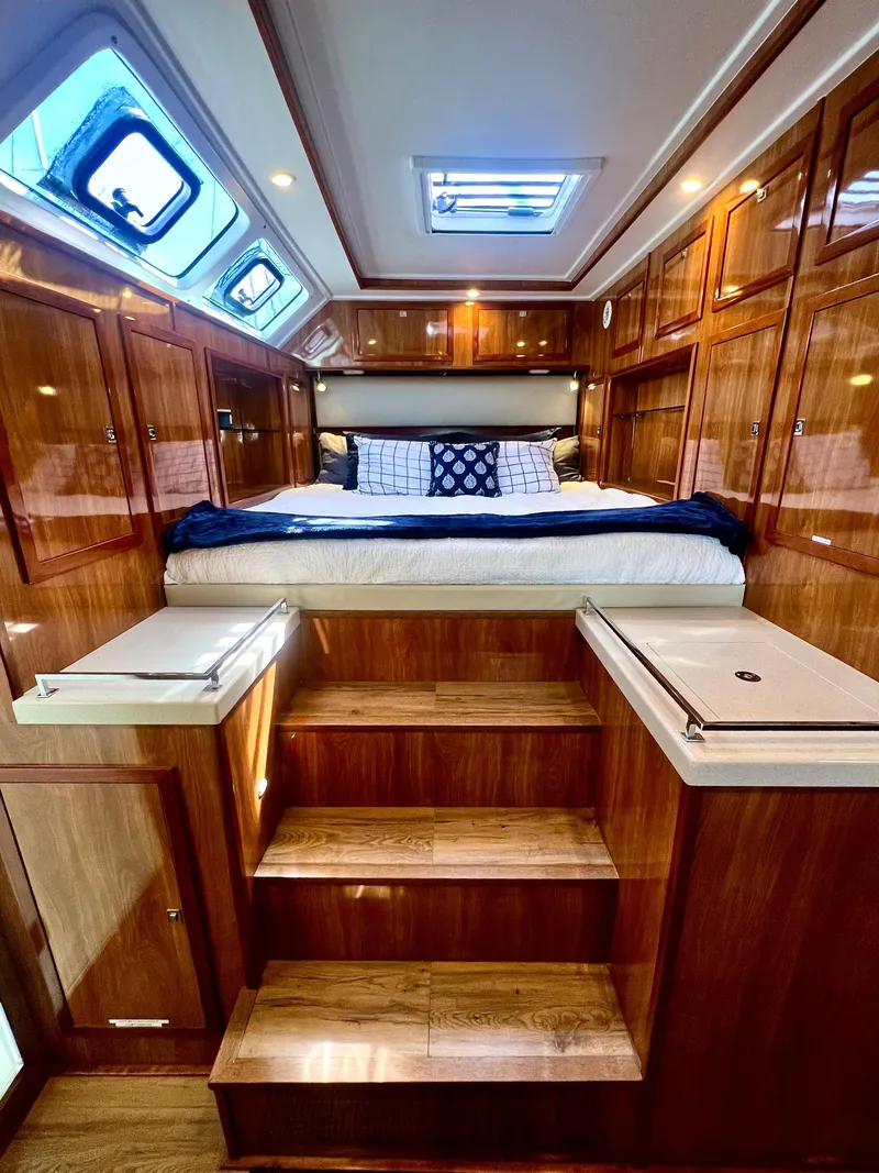Slide: The Image of Luxurious 2019 Royal Cape Catamarans 530 cabin with wooden interior and cozy bed. - 45