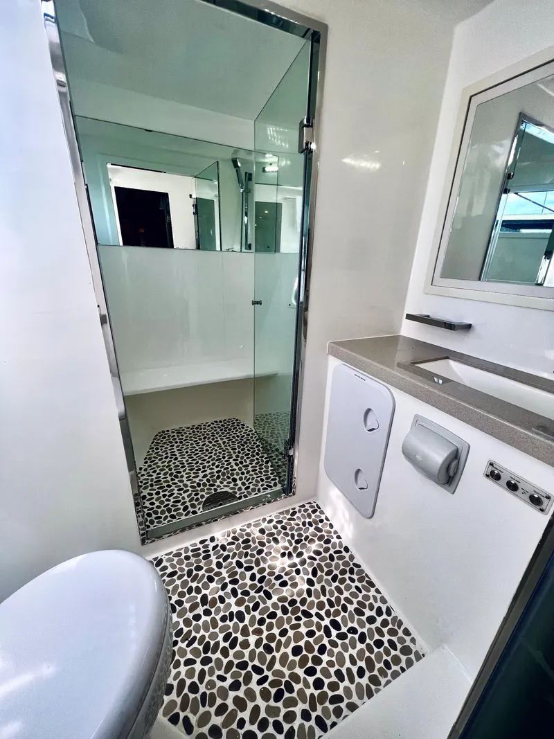 Slide: The Image of Modern bathroom in 2019 Royal Cape Catamarans 530 with pebble floor and glass shower. - 47