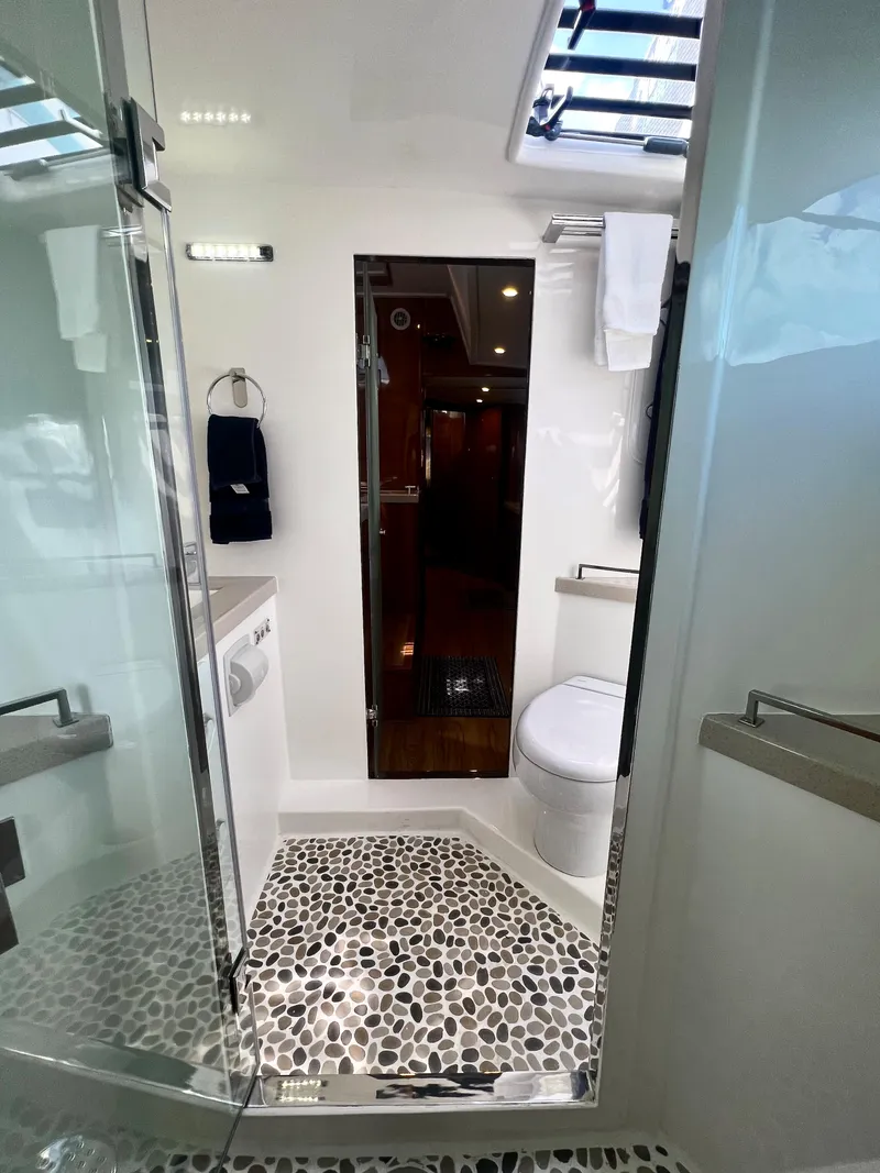 Slide: The Image of Luxurious bathroom in 2019 Royal Cape Catamarans 530 with modern fixtures and pebble flooring. - 48