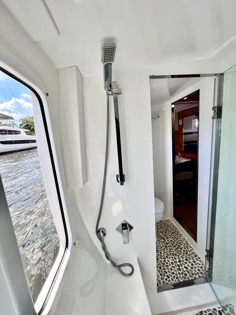 Slide: The Image of Luxurious bathroom on 2019 Royal Cape Catamarans 530 with modern shower and scenic window view. - 51