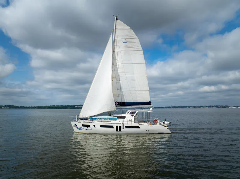 Slide: The Image of 2019 Royal Cape Catamarans Majestic 530 sailing on calm waters under cloudy skies. - 6