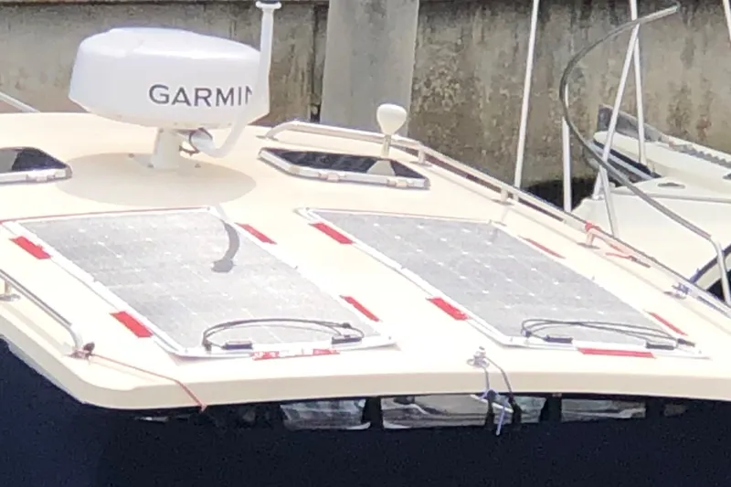Slide: The Image of 2004 Mainship Pilot 30-II Sedan with solar panels and Garmin radar on deck. - 15
