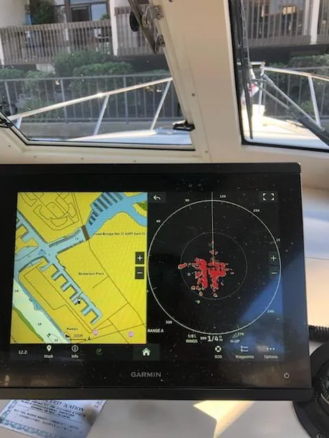 Slide: The Image of Navigation system on 2004 Mainship Pilot 30-II Sedan boat, displaying map and radar. - 18