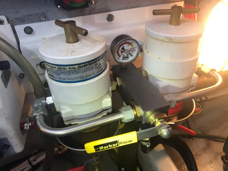 Slide: The Image of 2004 Mainship Pilot 30-II Sedan diesel fuel filter system with pressure gauge and Racor components. - 22