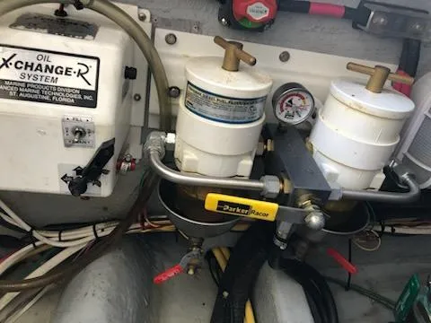 Slide: The Image of Engine room of 2004 Mainship Pilot 30-II Sedan with oil exchange system and fuel filters. - 23