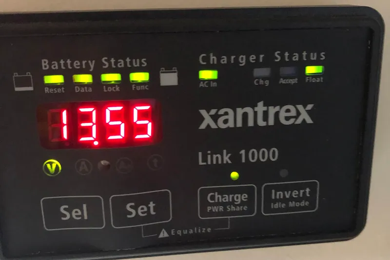 Slide: The Image of Xantrex Link 1000 battery monitor displaying 13.55 volts on a Mainship Pilot 30-II Sedan, 2004. - 24