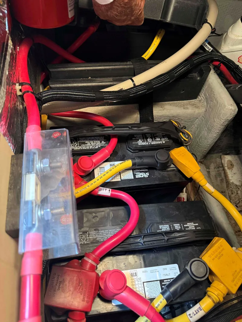 Slide: The Image of Battery compartment of a 2004 Mainship Pilot 30-II Sedan with cables and connectors. - 27